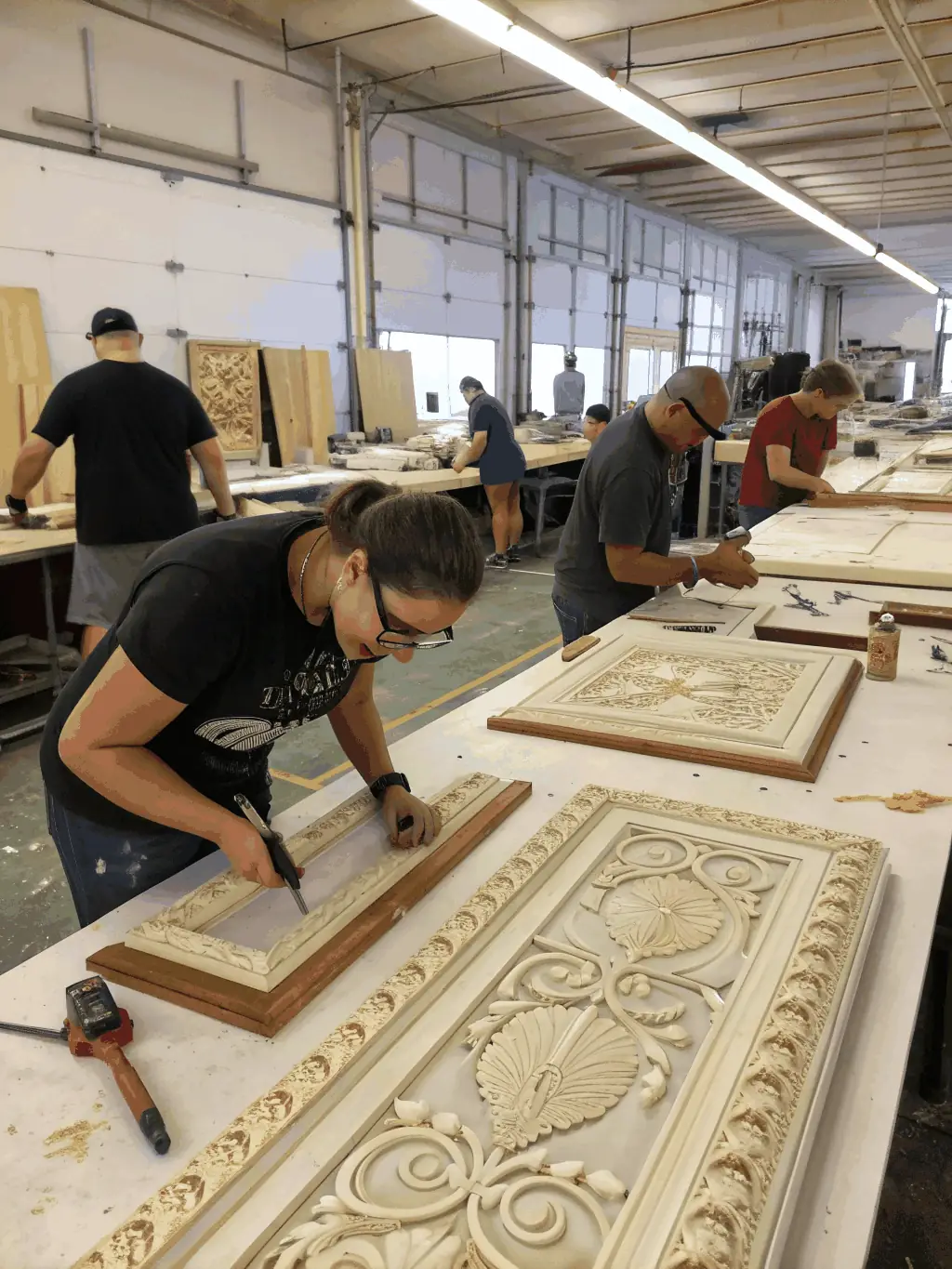 A photo showcasing volunteers restoring a historic sailing vessel at the La Rochelle Maritime Museum, with focus on the intricate woodwork.